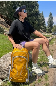 Close-up of bright yellow hiking backpack with durable nylon fabric and logo detail