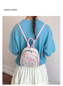 Rear view of a model wearing the mini floral backpack with pink leather straps