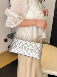 Silver quilted crossbody bag with metallic CLEAROK logo and chain strap for women