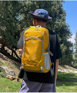 Detail of a bright yellow 40L outdoor hiking backpack with breathable mesh pockets
