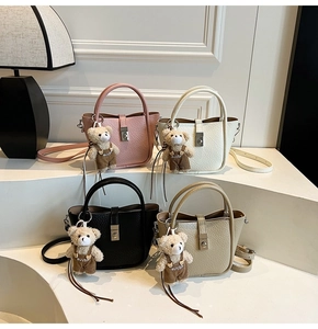 Collection of chic bucket bags in four colors with cute plush bear charms and textures