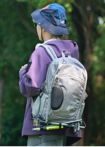 Detail view of 40L outdoor hiking backpack with trekking pole and professional gear hanging