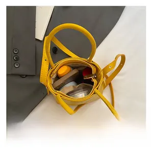 Interior view of yellow circular mini bag showing capacity for cosmetics and small items