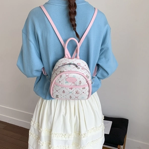 Rear view of a model wearing the cute mini backpack with bear and ice cream prints