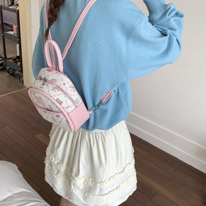 Detailed back view of a pink floral mini backpack with bear print and silver hardware