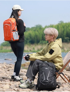 Detail showing 40L outdoor hiking backpacks in orange and black with secure buckle straps