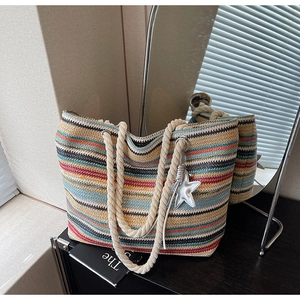 Detail of colorful woven tote bag with cotton rope handles and star pendant charm