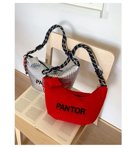 Detail of silver and red crescent shoulder bags with PANTOR embroidery and rope handles
