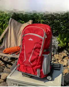 Outdoor 40L red hiking backpack with multiple pockets shown in a real camping scenario