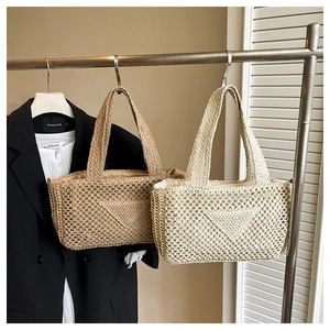 Detailed close-up of woven tote bags featuring geometric triangle texture in a lifestyle setting