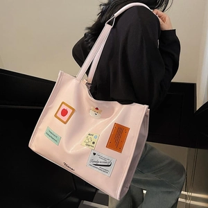 Pink PU leather tote bag with embroidery patches and Nora script text in daily casual style