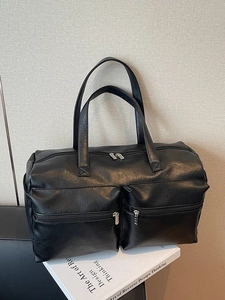 Large black leather travel tote bag with double front pockets and spacious main compartment