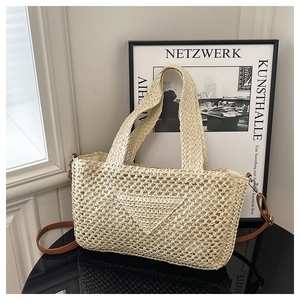 Detail of hand-woven off-white knit tote with triangular pattern and leather strap