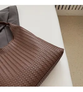Close-up of brown leather intrecciato woven hobo bag showing texture and craftsmanship