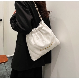Detailed close-up of white quilted leather tote bag with gold CLEAROK logo and chain strap