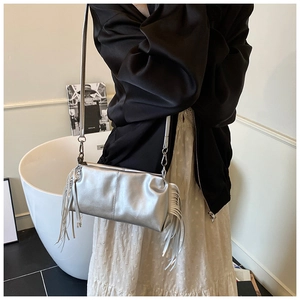 Silver metallic rectangular crossbody bag featuring long fringe tassels and thin strap