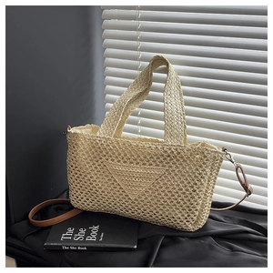 Detailed knit pattern on a beige woven tote with brown faux leather shoulder strap