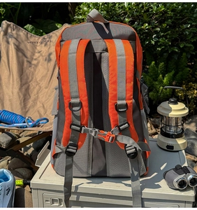 Breathable mesh back panel and adjustable chest buckle on orange outdoor backpack