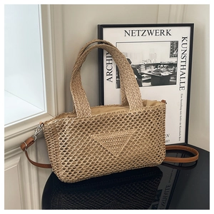 Macro detail of beige woven tote bag with triangular pattern and brown leather strap