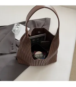 Interior view of brown woven hobo bag showing spacious capacity for iPad and essentials