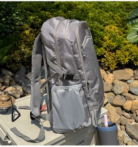 Macro view of grey waterproof hiking backpack with side mesh pockets and adjustable buckles