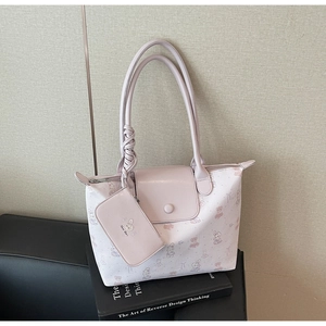 Detail of pink cartoon tote bag showing faux leather texture and small bear print