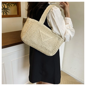 Detail of a large beige knit tote bag with mesh pattern for summer beach vacations