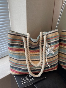 Colorful striped woven tote bag with rope handles and star pendant for summer beach vacations