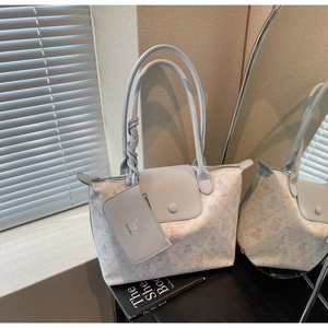 Close-up of light blue tote bag with cute cartoon rabbit print and matching pouch