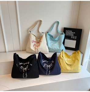 Detailed shot of large canvas tote bags in five colors with adjustable shoulder straps