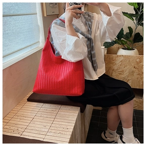 Detail of red woven hobo bag showing intricate leather craftsmanship and large capacity