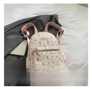 Detail of pink and white backpack featuring cute cartoon bear prints and metal zipper pocket