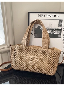 Large woven knit beach bag with leather strap and triangular design in khaki color