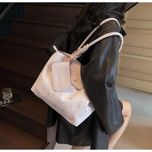 Close-up of pink tote bag set with cute cartoon prints and knotted shoulder strap