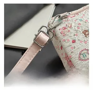 Detail of adjustable pink PU leather strap with silver buckle and embossed texture
