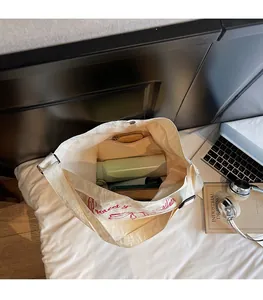 Top view of large canvas tote bag interior showing spacious main compartment and zip pocket