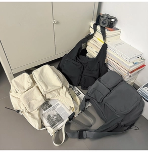 Detailed view of cargo messenger bags in beige, black, and grey with multiple pockets