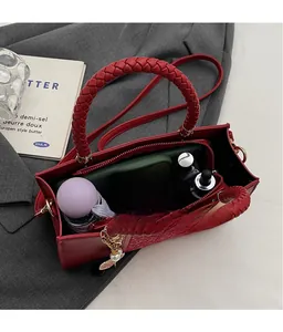 Top view of red leather handbag interior showing large capacity for umbrella and wallet