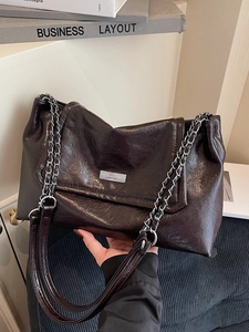 Deep brown oil wax leather tote bag with silver chain strap and polished finish