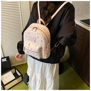 Mini floral backpack with bear prints shown on a model for actual size and fit