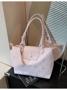 Pink tote bag with cartoon bear prints and unique woven handle in a lifestyle mirror shot