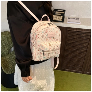 Detail view of floral backpack featuring bear prints and adjustable pink straps