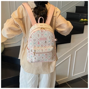 Close-up of cute cartoon bear print and front zipper pocket on pink and white backpack