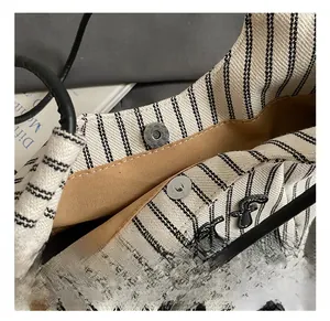Close-up of the magnetic clasp and yellow fabric lining on this striped canvas tote