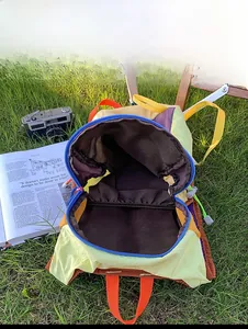 Top down view showing spacious interior with pockets of this colorful hiking backpack