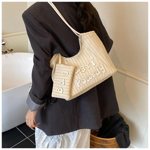 Close-up of yellow and white striped canvas tote bag with 3D letter patchwork and coin pouch