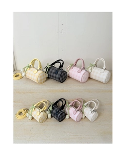 Detail showing checkered cylinder pillow bags in four colors with tulip charms