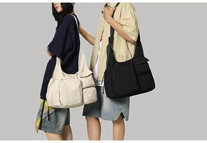 Close-up of neutral canvas messenger bag showing multiple utility pockets and texture