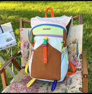 Detail of multi-color nylon outdoor backpack featuring stylish patchwork and buckles