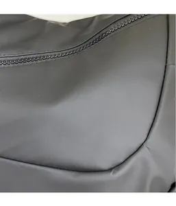 Macro detail of lightweight black nylon fabric with fine zipper on a dumpling bag